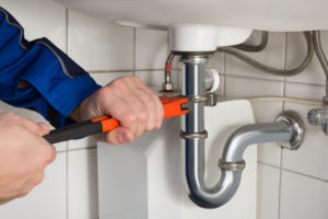 plumber fixing bathroom pipes